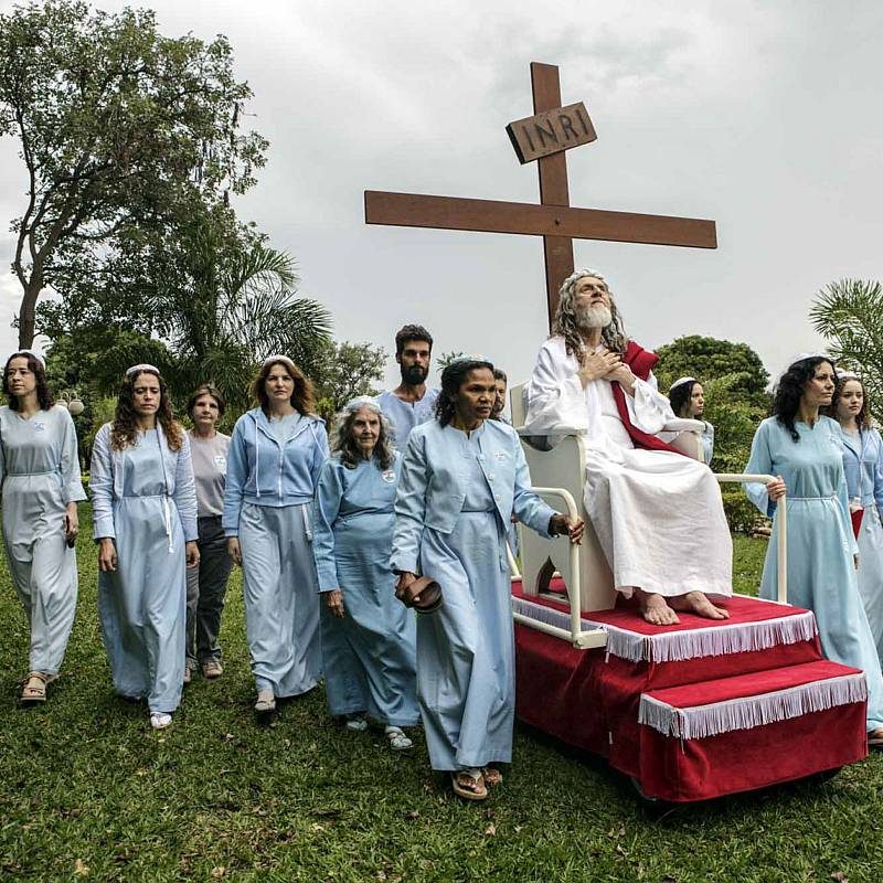 Brazil. 2014. Brasilia.
INRI Cristo’s disciples rolling him around on the compound grounds on his rolling pedestal.

INRI (born Alvaro Theiss) takes his rst name from the initials of the inscription the Romans placed on the cross to spite him 2,000 years ago: Iesus Nazarenus Rex Iudaeorum, or Jesus of Nazareth, King of the Jews. The first awaking as the Christ came already in 1979 during a fast in Santiago of Chile, and INRI subsequently spent many years as a wandering preacher before settling in New Jerusalem, which is located outside of Brasilia.

Most of the dozen or so disciples who live inside INRI’s compound are women. While the 69-year old Saviour and his followers live a private and secluded life, they are also busy disseminating his teachings to the world via the Internet, using YouTube, music videos and live broadcasts of sermons. From the book “The Last Testament”.